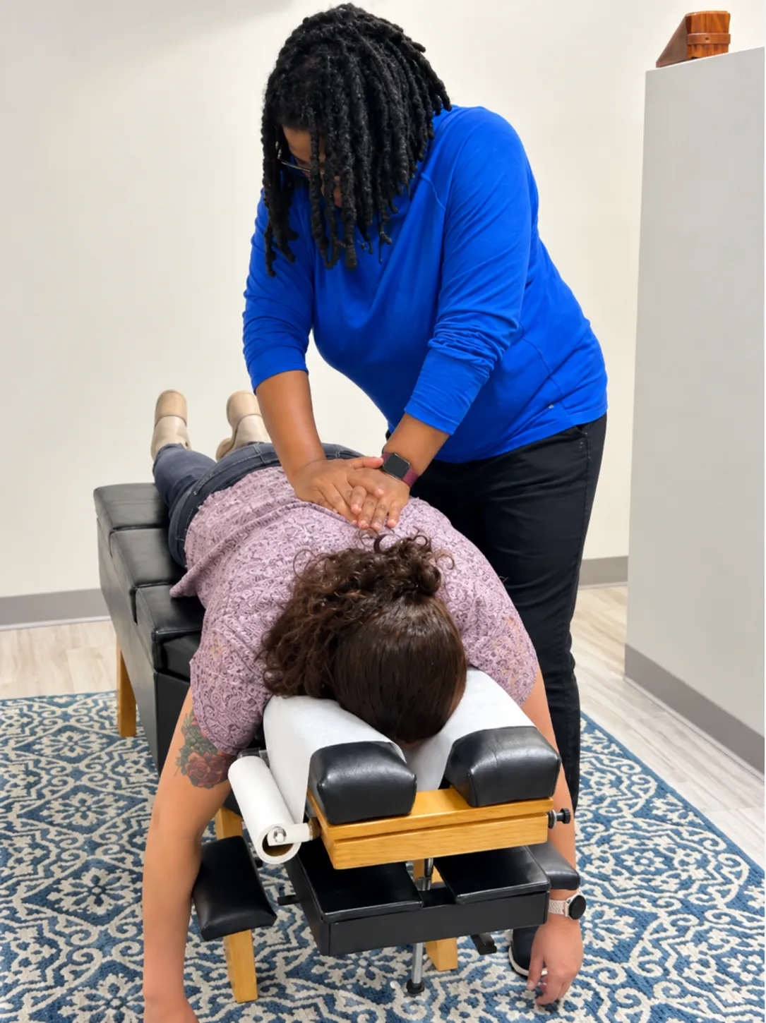 Chiropractor showing a spine model to a patient