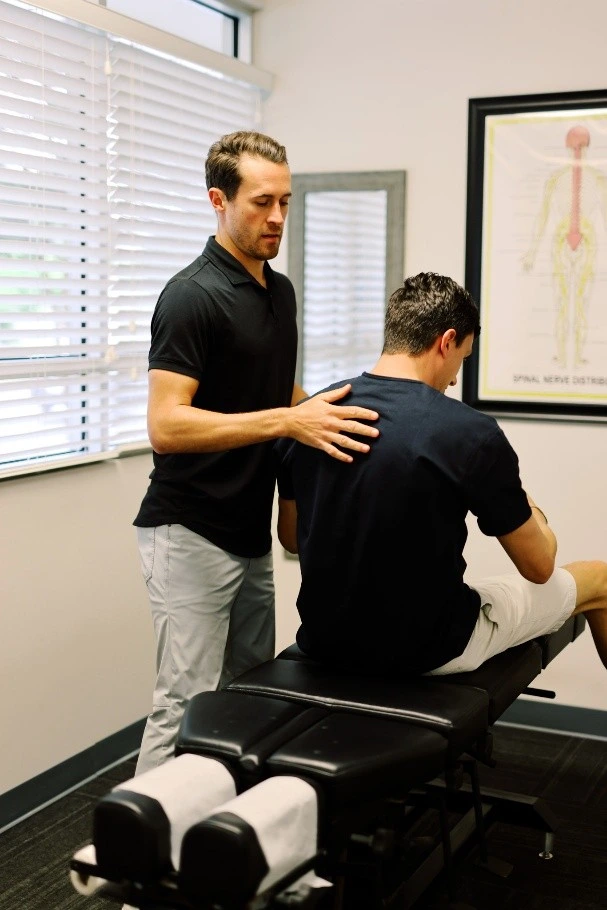 Chiropractor explaining spine care to a patient