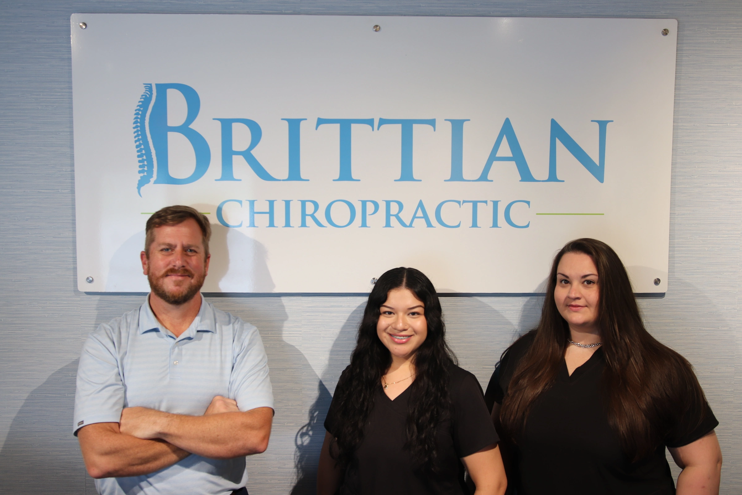 Chiropractor showing a spine model to a patient
