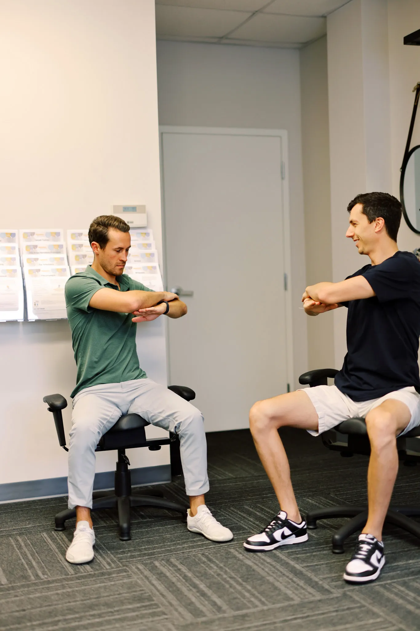 Chiropractor showing a spine model to a patient